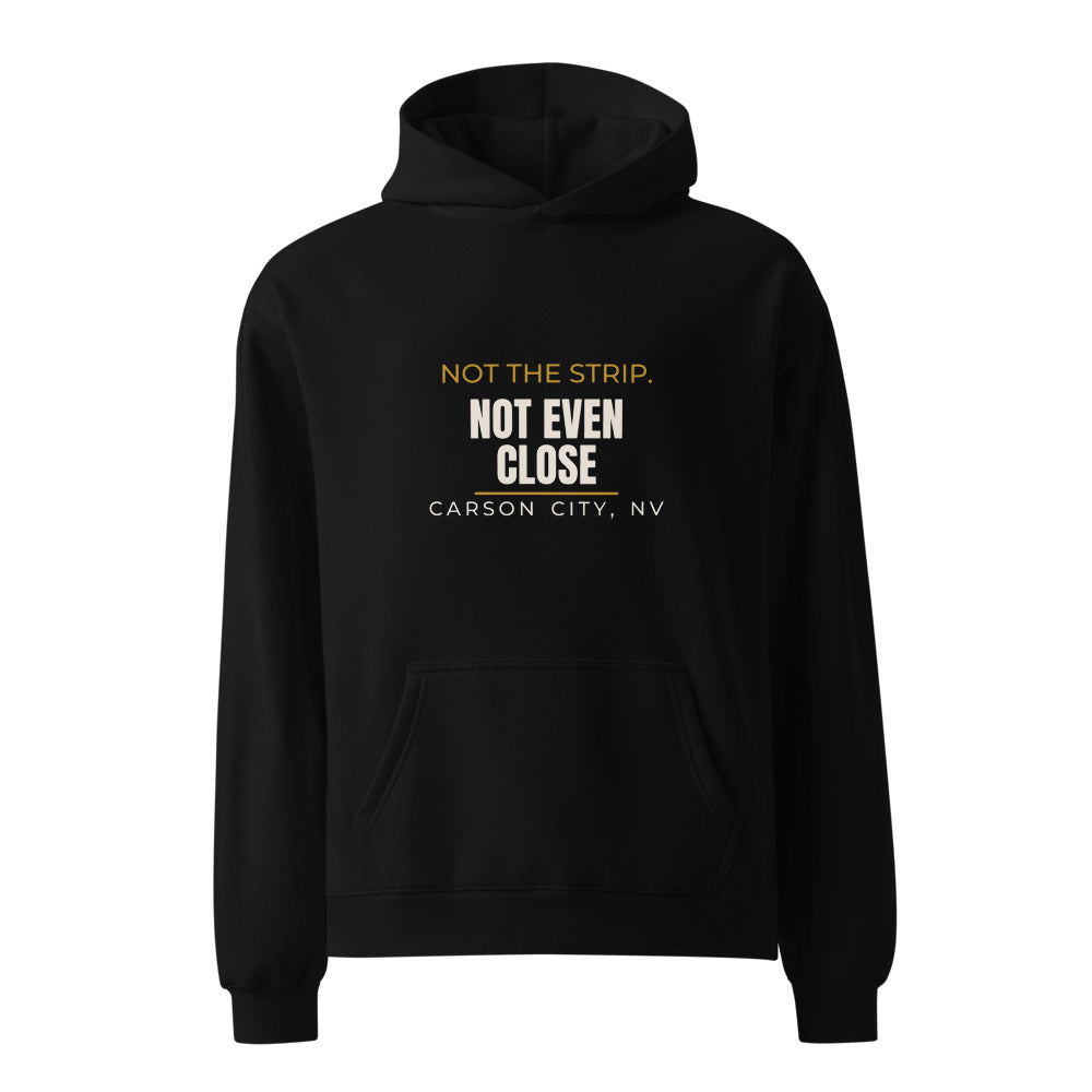 Black hoodie with Not The Strip. Not Even Close. Carson City capital slogan print