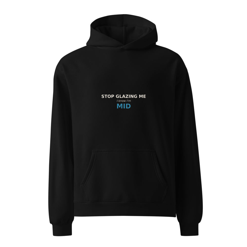 Stop Glazing Me I Know I'm Mid black hoodie front in white studio | Kreativ